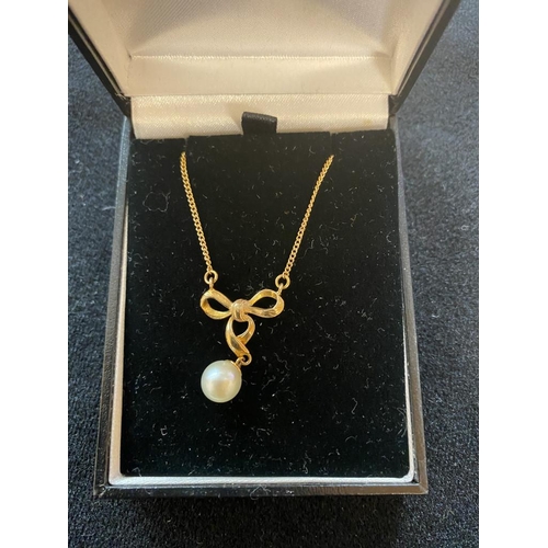 105 - Hallmarked 9ct gold pearl drop necklace in bow design