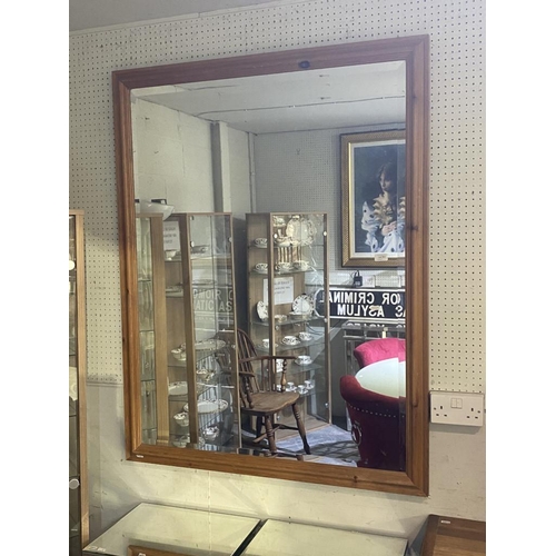 561 - Pine framed bevel edged mirror (104 x 136cm)