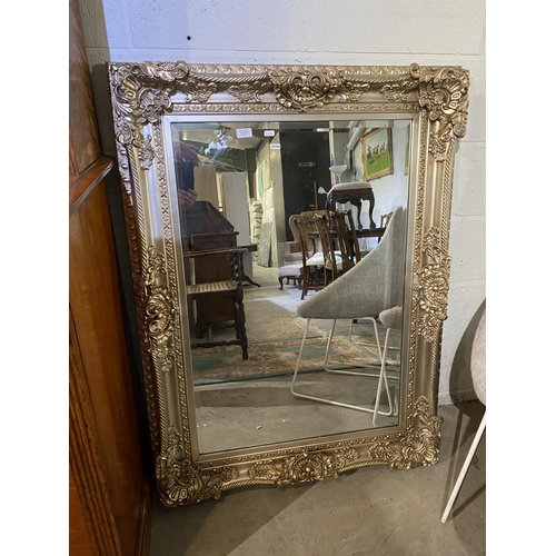 111 - Heavily carved silver gilt wall mirror (90x120cm)