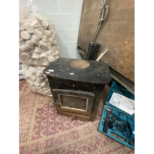 224 - Cast wood burning stove (54H 44W 33D cm) & flue (sold as seen)