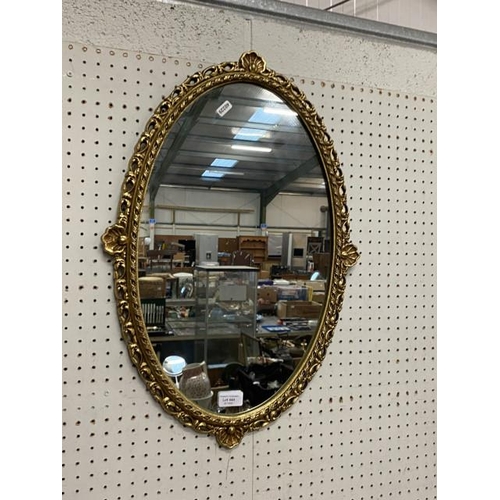 444 - Metal gilt framed oval mirror (64x35cm)