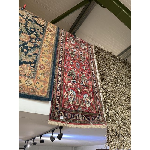 44 - Red ground Persian style rug 290 x 74cm