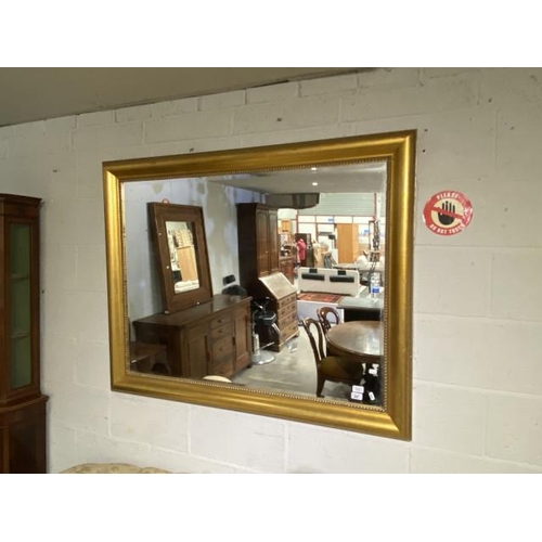 77 - Gilt framed bevel edged wall mirror (106x134cm)