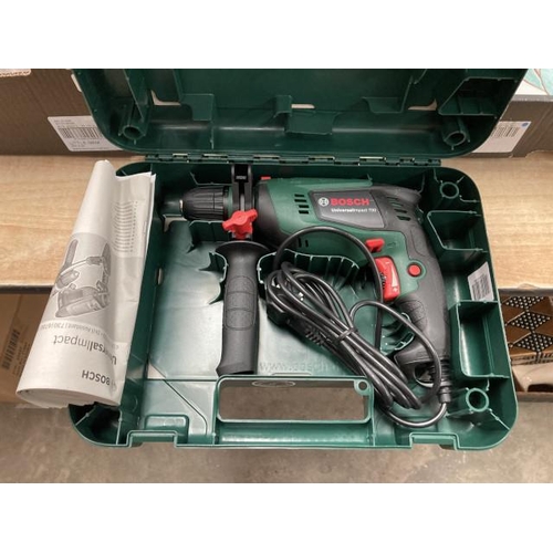 282 - Cased Bosch 700 impact drill with manual