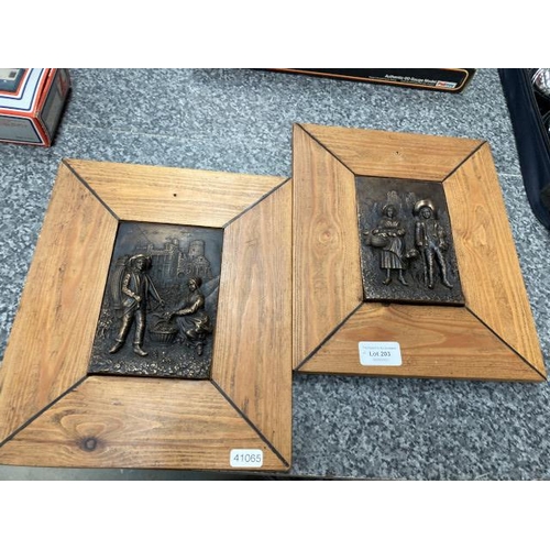 203 - 2 pine framed bronze plaques (24x28cm)