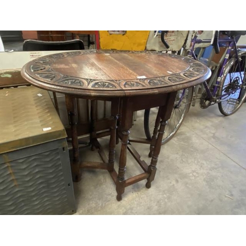 230 - Carved oak drop leaf table 72H 92W 63D