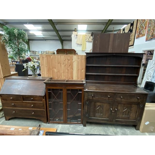 130 - Oak bureau 104H 107W 47D, mahogany glazed bookcase 105H 89W 27D and an oak linen fold dresser 165H 1... 