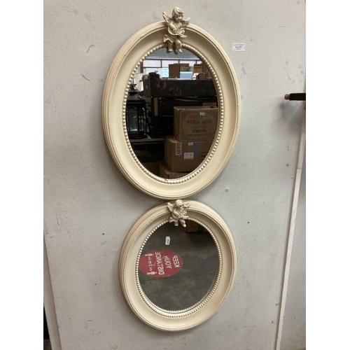 321 - 2 cream framed oval cherub mirrors 40x50cm