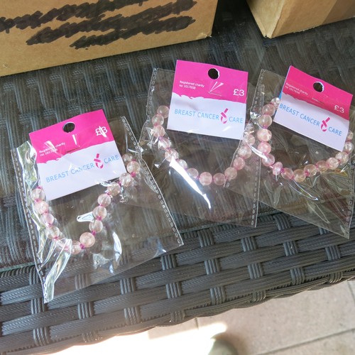 488 - 3 boxes of approximately 369 pink bracelets