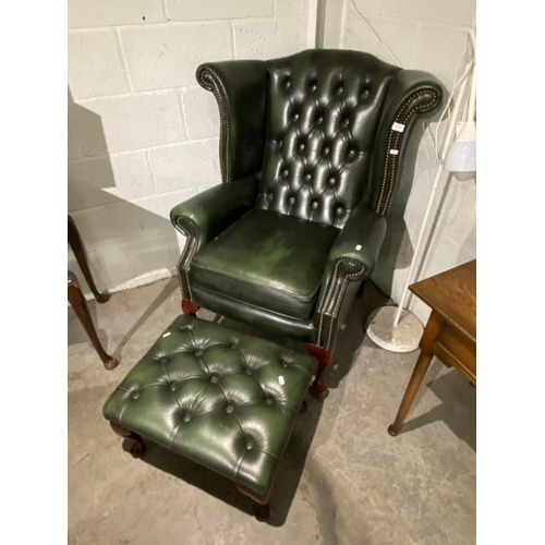 179 - Green leather button back Chesterfield wing armchair 81W and a matching footstool 23H 57W 45D