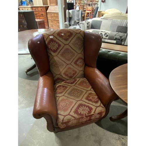 181 - Leather and upholstered wing armchair 92W