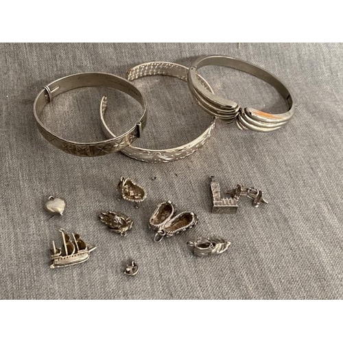 285 - Silver bangle, 8 vintage charms inc. silver & 2 bangles