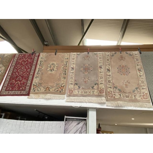 493 - 3 Chinese style rugs - all 163 x 91cm  and a red ground rug 147 x 80cm