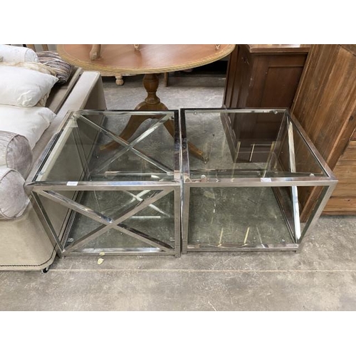 190 - Pair of chrome and glass occasional tables 50H 60W 60D (New ex show home)