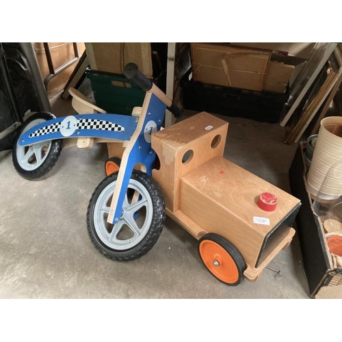 554 - Child’s balance bike and a wooden train