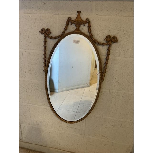 244 - Oval gilt framed bevel edged mirror 39x79cm