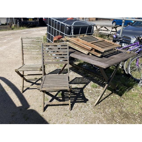 513 - Teak garden table 72H 149W 87D and 4 folding chairs