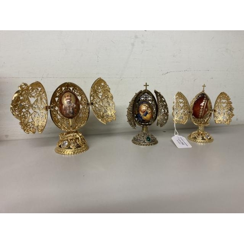 240 - A Russian filigree folding egg shaped frame, containing egg with Madonna & child & two AKM St. Peter... 