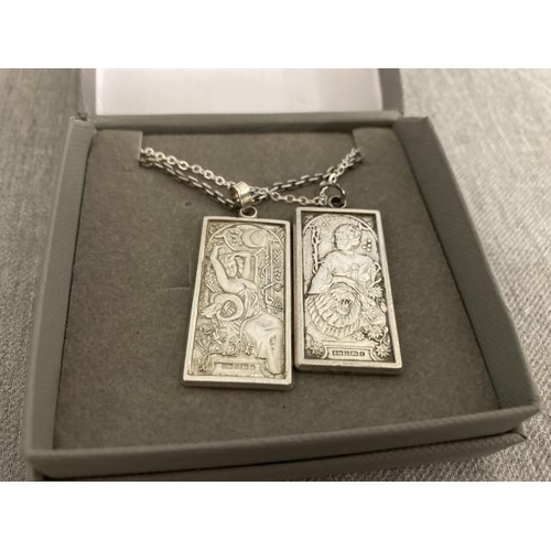 253 - Two silver cast Art Nouveau design ingots on chains