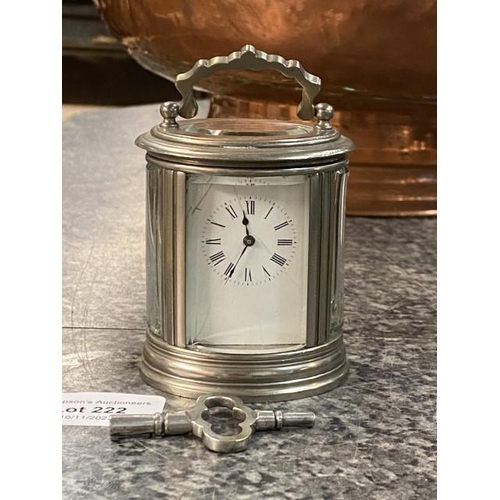 222 - Oval silver plated carriage/travelling clock with white enamel dial and key 7cm