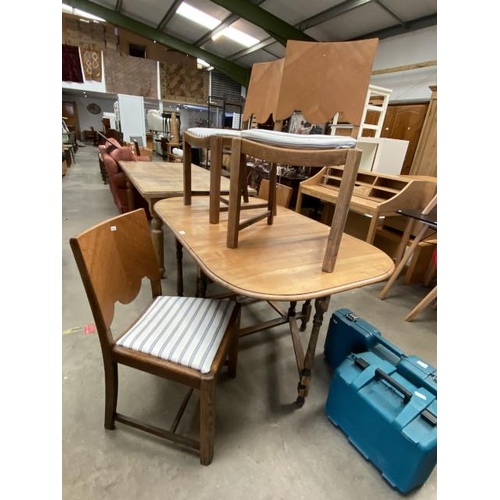 79 - 1950’s oak drop leaf table 73H 145W 90D and 4 chairs