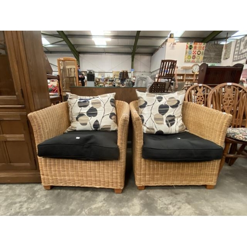 86 - Pair of wicker armchairs with seat pads and cushions 74W