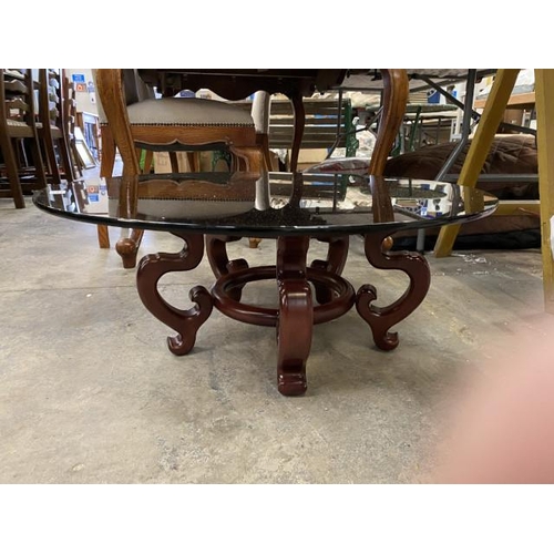 178 - Chinese hardwood based occasional table with smoked glass top 30H 76cm diameter