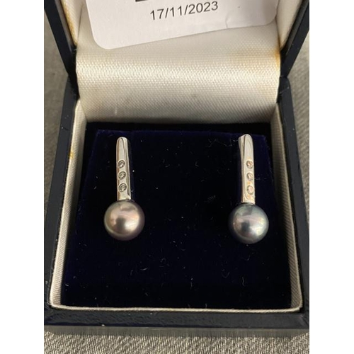 276 - 9ct white gold diamond and black pearl drop earrings