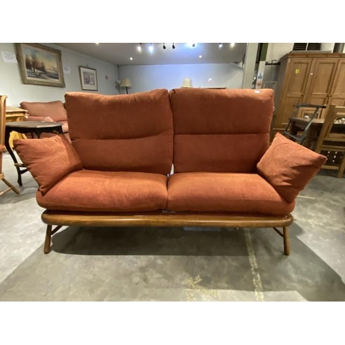 40 - Ercol elm settee upholstered in terracotta chenille fabric  180W