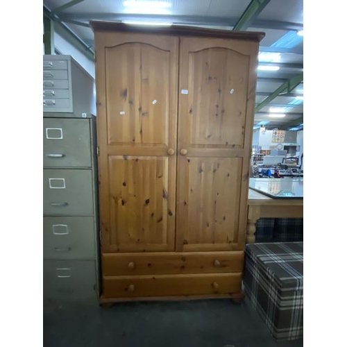 7 - Pine 2 door/2 drawer wardrobe with hanging rail to the interior. 181H 100W 53D