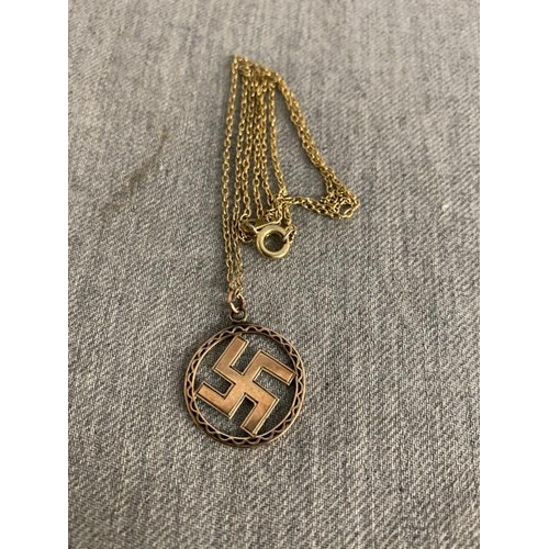 264 - 9ct gold swastika pendant 1.1g on gilt chain