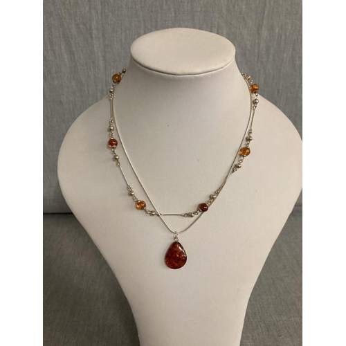 389 - 2 silver & amber necklaces