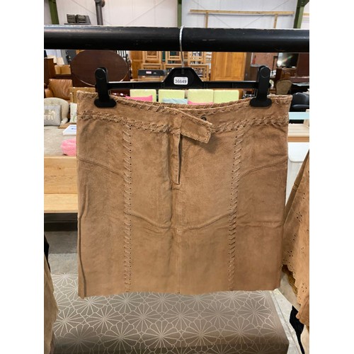 181 - 8 suede skirts (sizes 12 & 14, new - one with broken zip) 2 suede jackets (size 14) 3 leather coats,... 