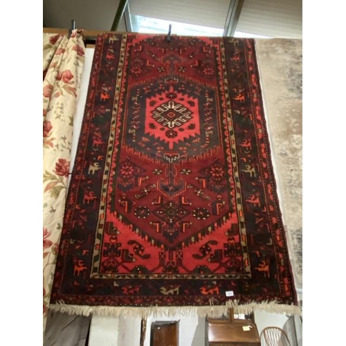 61 - Red ground Persian carpet 129 x 237cm