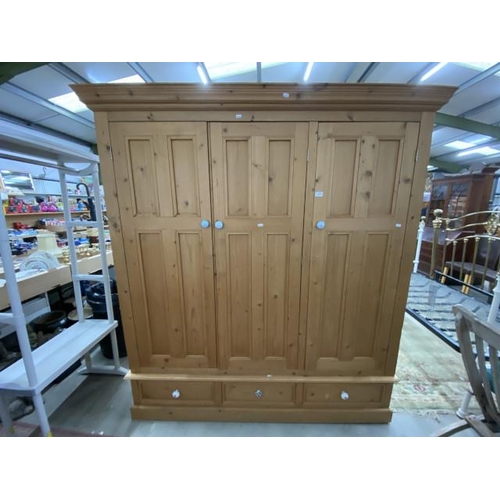 283 - Pine 3 door/3 drawer wardrobe with hanging rails to the interior 192H 180W 62D