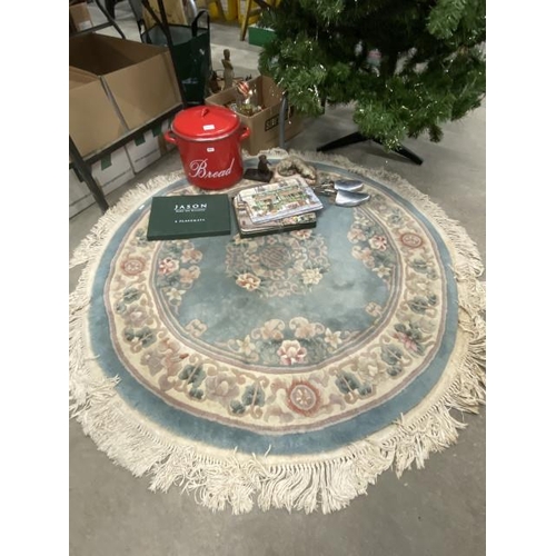 557 - Blue Chinese style rug 4ft Diam, red enamel bread bin, boxed place mats, shoe stretchers etc.