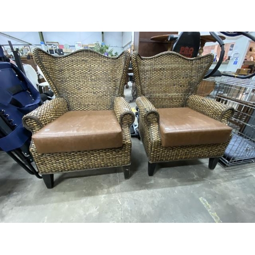 127 - Pair of wicker conservatory chairs with brown faux leather seat pads 86W