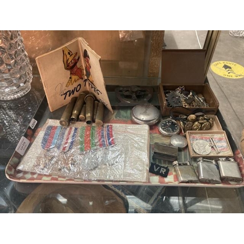 Tray of military collectables inc. Defence medal, War medal 1939-45, France & Germany star, 1939-45 star for Sergeant Ryan J.K. 972578, gunners sighting level, vesta case, cap badges, buttons, military pocket watch, The 'Two Types' by Jon, brass cartridges etc.