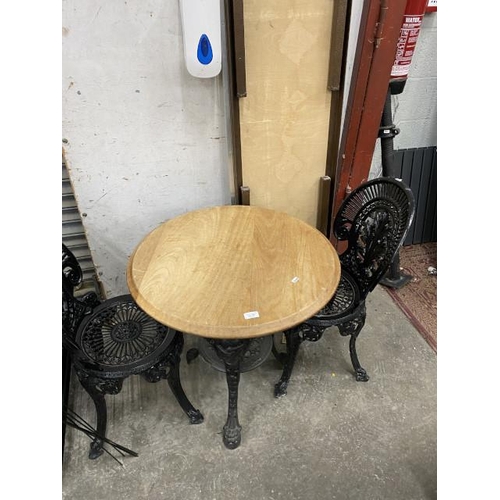 164 - Pine topped cast pub/garden table 70H 69cm diameter and 2 cast chairs