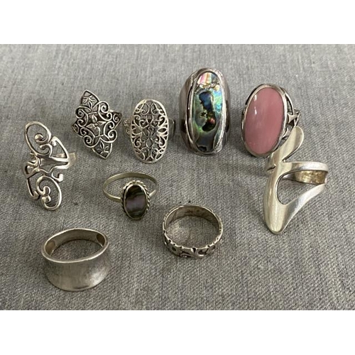 317 - 9 silver rings of various sizes inc. Paua Shell