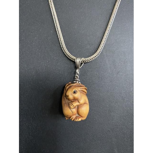 243 - Chinese carved rabbit netsuke pendant (signed to base) on a silver chain