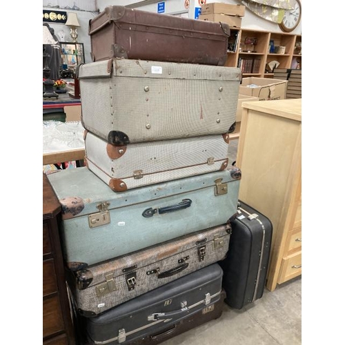 497 - Assorted vintage suitcases including Antler