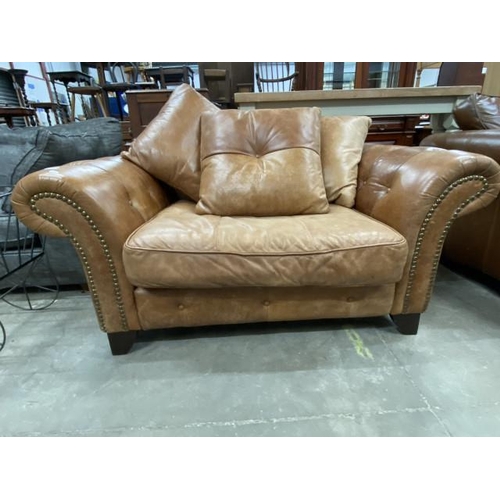 99 - Tan leather armchair with button back detail and scatter cushions 150W