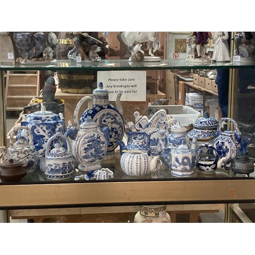 514 - 13 oriental blue & white teapots & 2 clay (1 teapot lid as found)