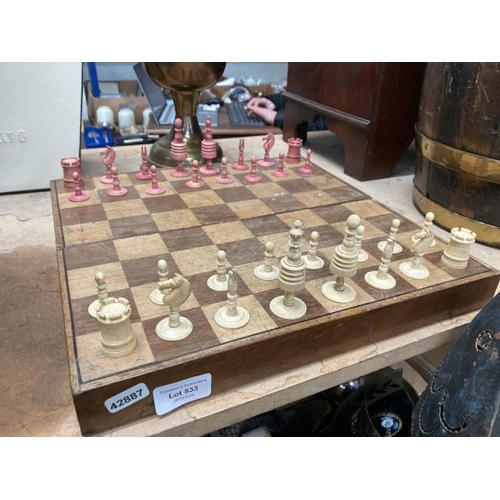 533 - Folding mahogany chess board with carved bone pieces