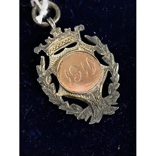 295 - 9ct gold fronted silver watch fob medal 1910