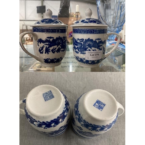 376 - Pair of blue & white Chinese dragon cups with covers, Reign marks to bases