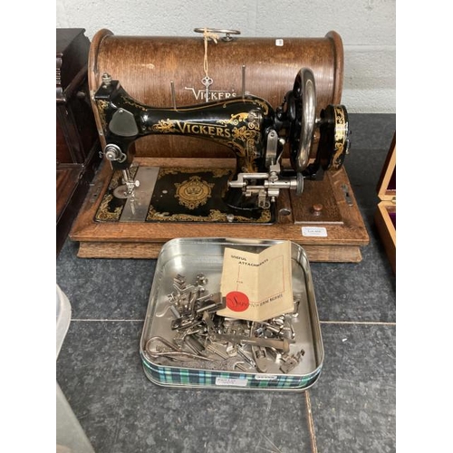 409 - Oak cased Vicker's Modele De Luxe 71704 sewing machine & a tin of mixed sewing machine accessories