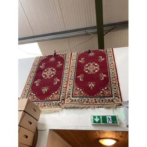 526 - 2 burgundy ground hearth rugs 150 x 83cm