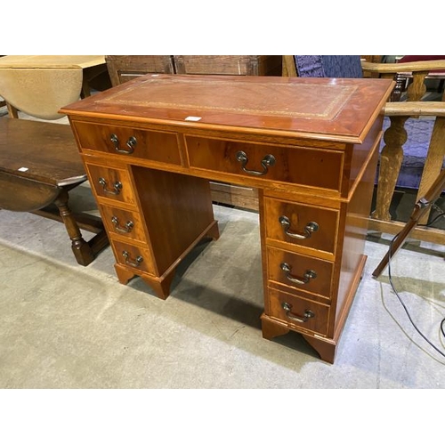 72 - Yew wood pedestal desk with brown leather inset 76H 91W 46D
